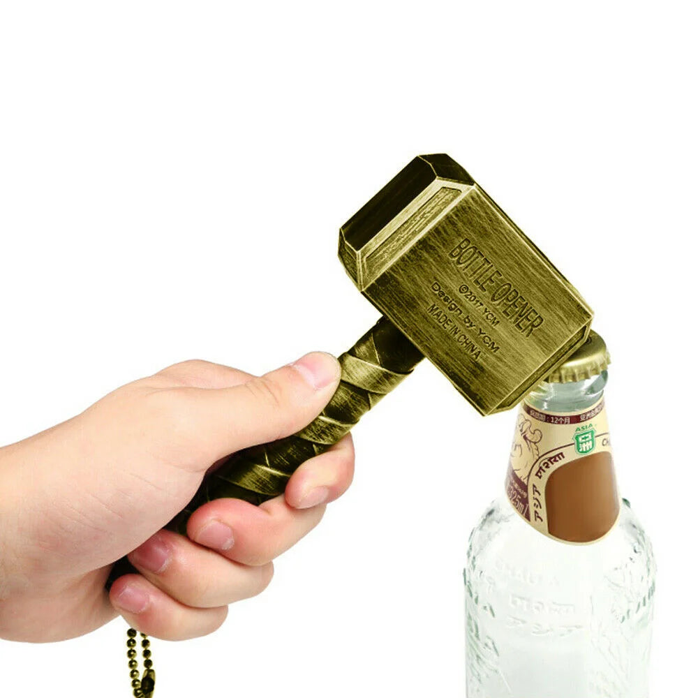 Person using a hammer-shaped bottle opener to open a beer bottle